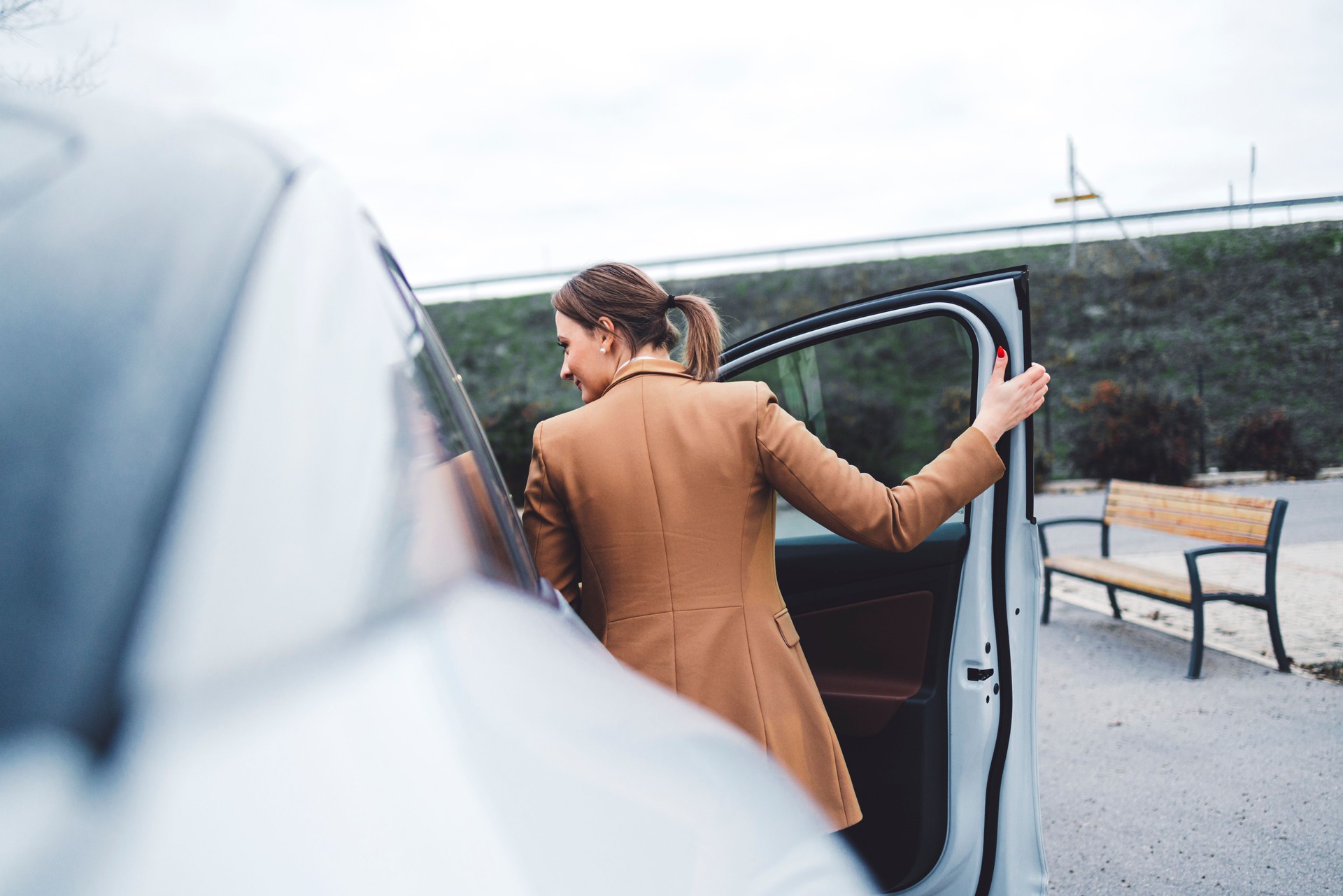 Woman is being picked up by car